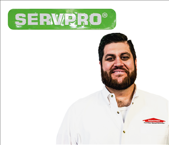 Ryan Millard for SERVPRO photo on white wall, male employee in white shirt