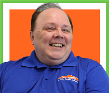 Bill Repsel for SERVPRO photo on white wall