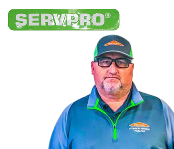 Jeff Williams for SERVPRO photo on white wall, male employee with hat on
