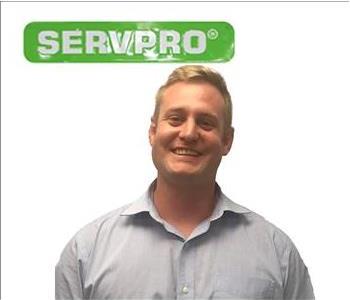 Tom, Male employee, SERVPRO green sign