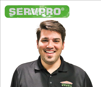 Gavin Parchman for SERVPRO photo on white wall, male employee with brown hair