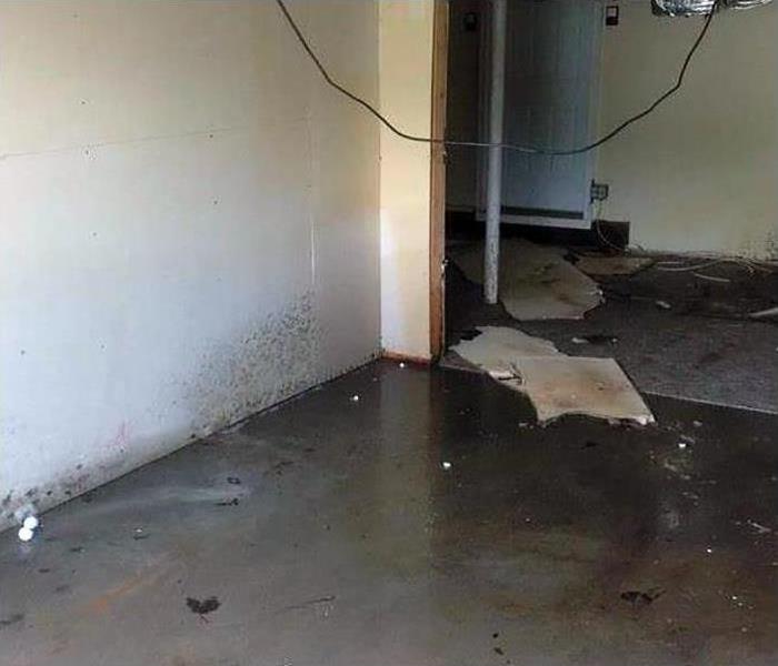 Water inside of garage leading into the home