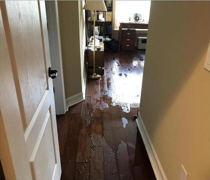 Water flooding hallway after a storm